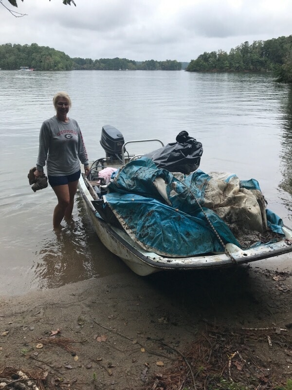 Shore Sweep volunteers bringing trash in on their boat