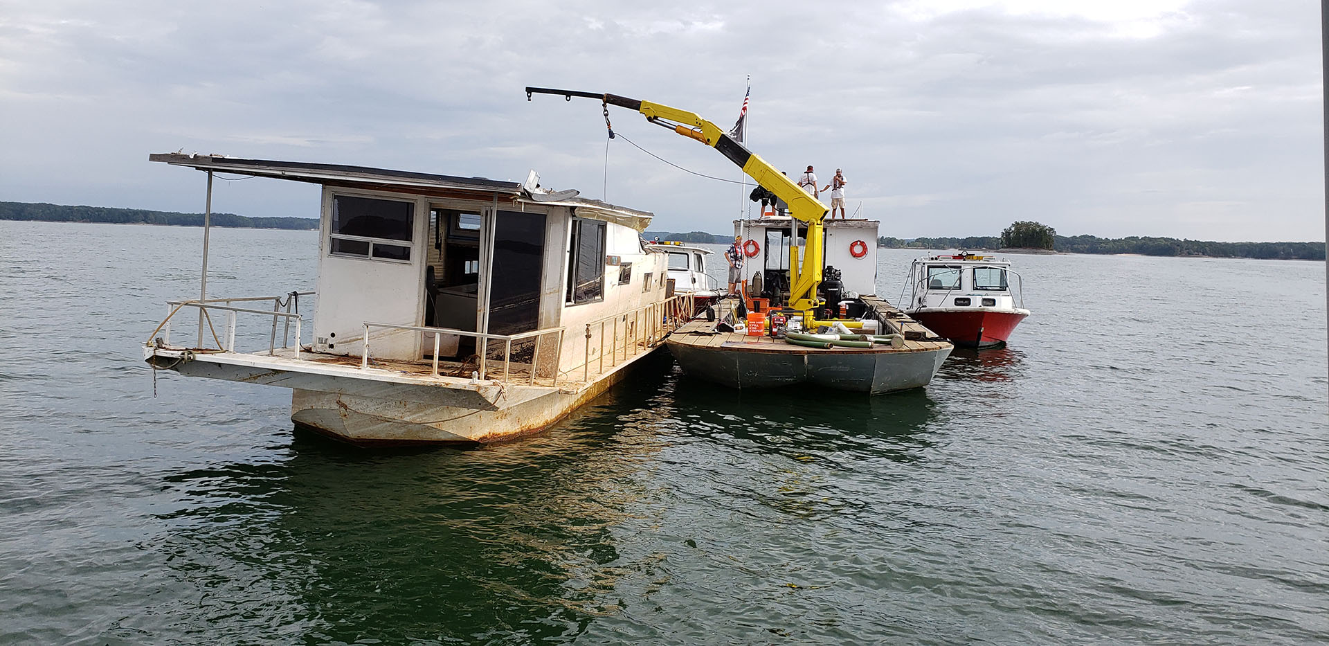 Workers attending to an abandoned boat